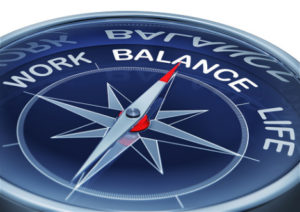 A compass needle points to "balance" between "work" and "life," representing work-life balance.