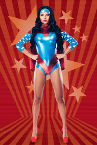 Wonder woman poses with her hands on her hips in a powerful stance in front of an animated background of red stars and stripes.
