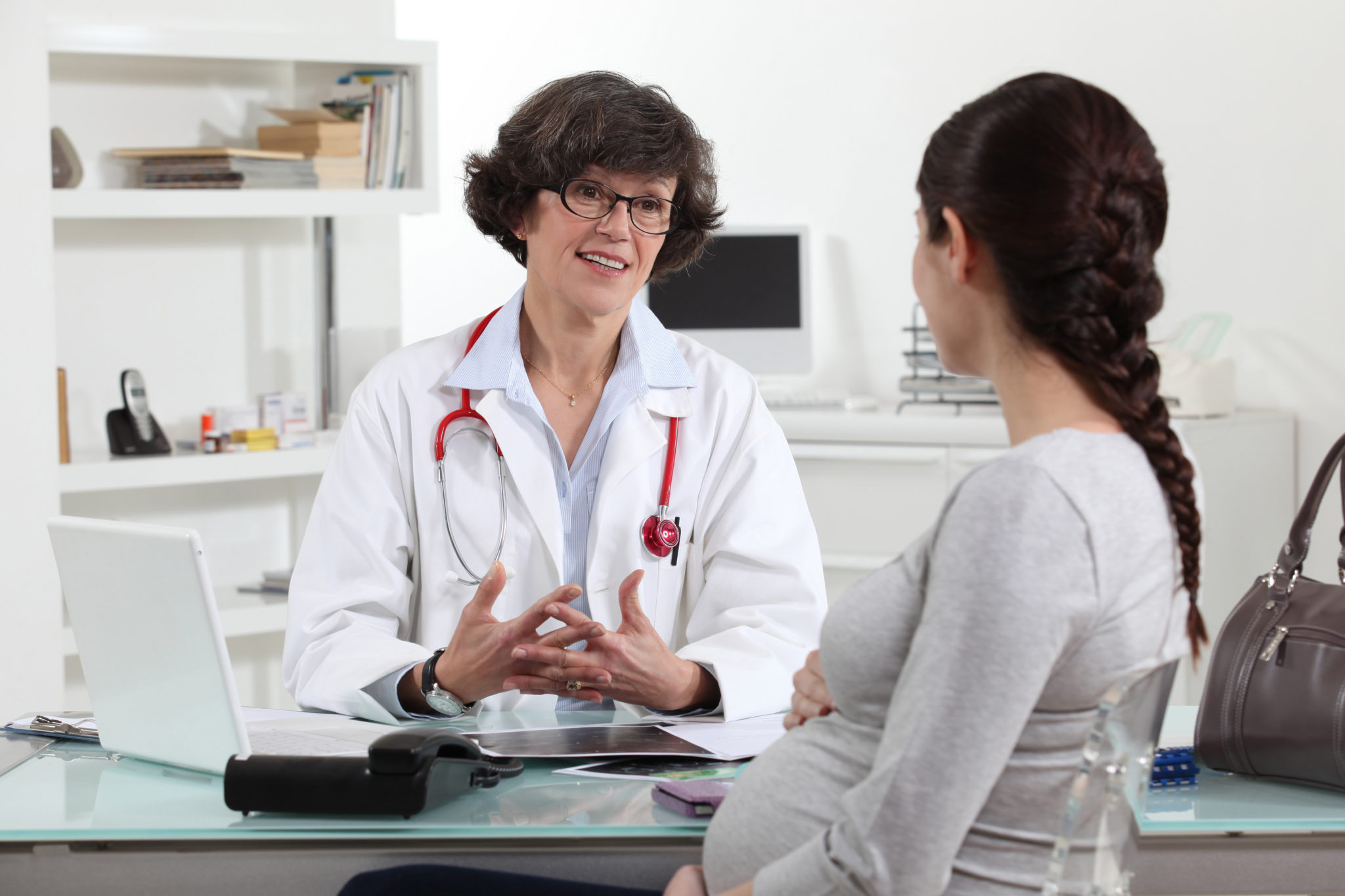 female doctor talking to her pregnant patient - WorkLife Law