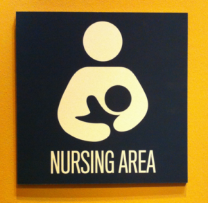 Sign that says "nursing area" and shows symbol of woman holding a baby