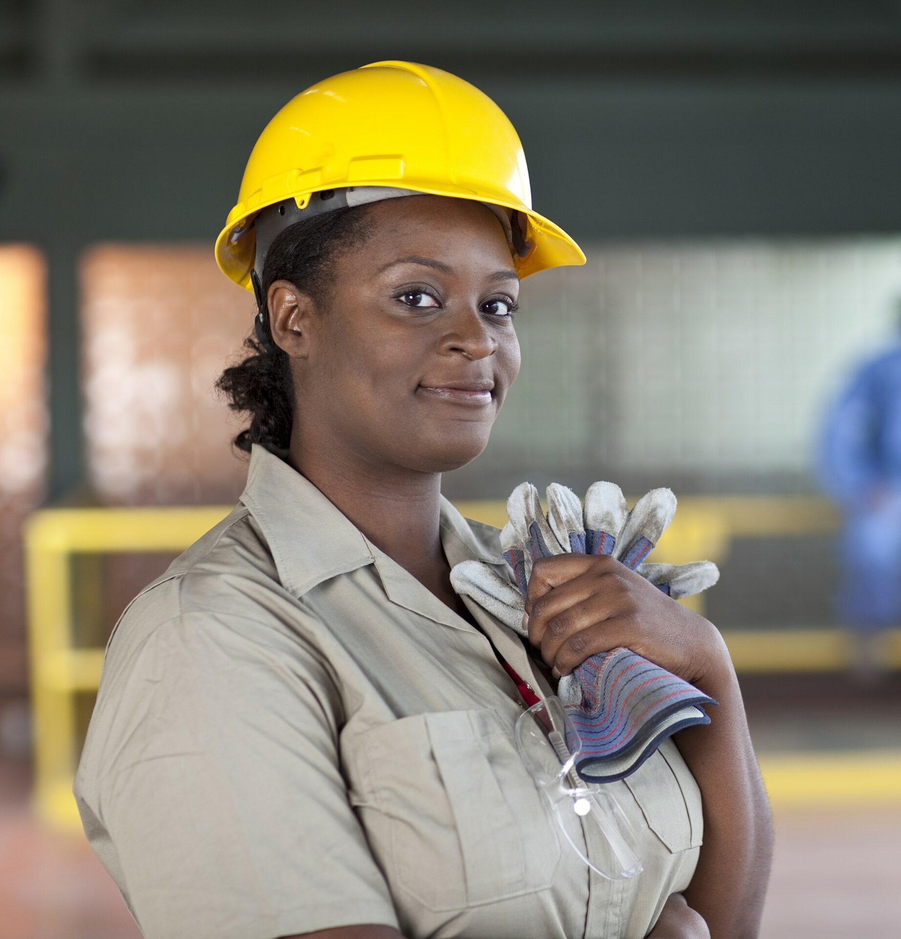 woman of color construction worker with yellow helmet